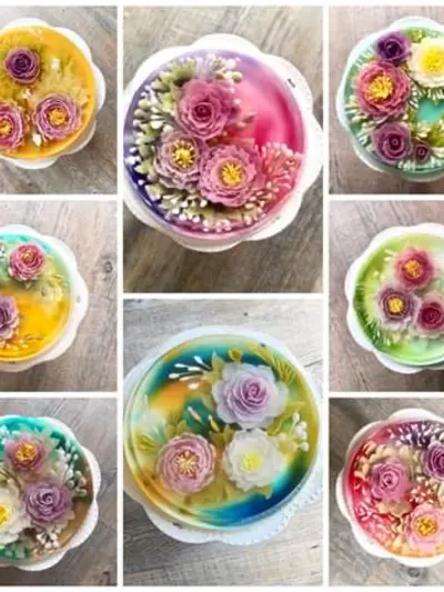 An array of translucent, encapsulation-style 3D jelly art cakes displaying vibrant internal floral structures like peonies and roses, crafted using precision needle-injection tools during an international culinary program.