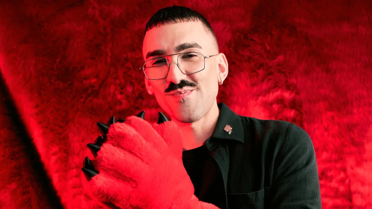Kill Boring Dead chief executive Marcus Willis, wearing glasses and a red furry claw glove, in front of a red fur backdrop
