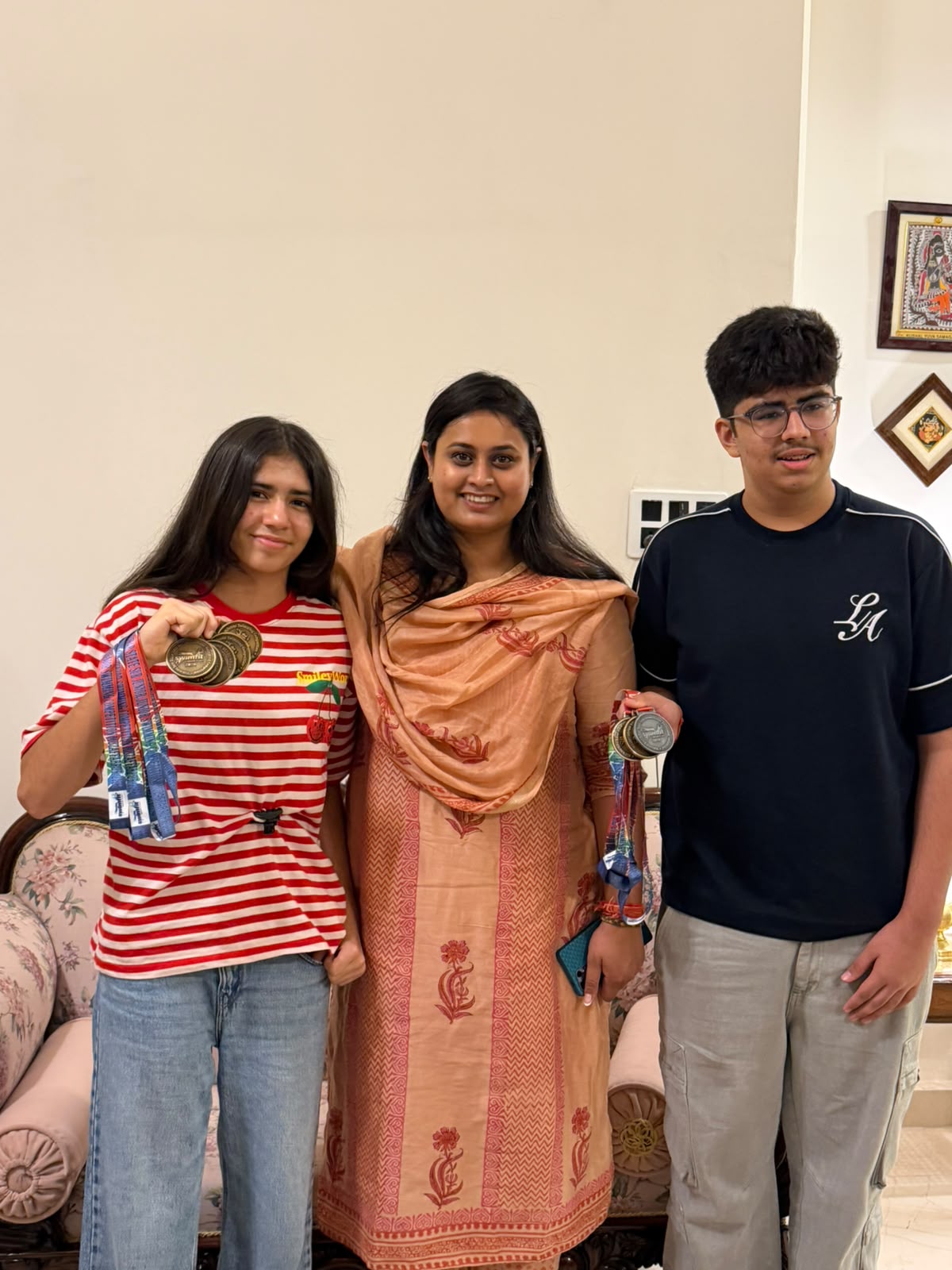 Hon'ble Sports Minister Mrs. Shreyasi Singh with Hridhi Singh, Group Champion of the 48th State Sub-Junior & Junior Swimming Championship, and Rudra Singh Rana, Gold Medalist.