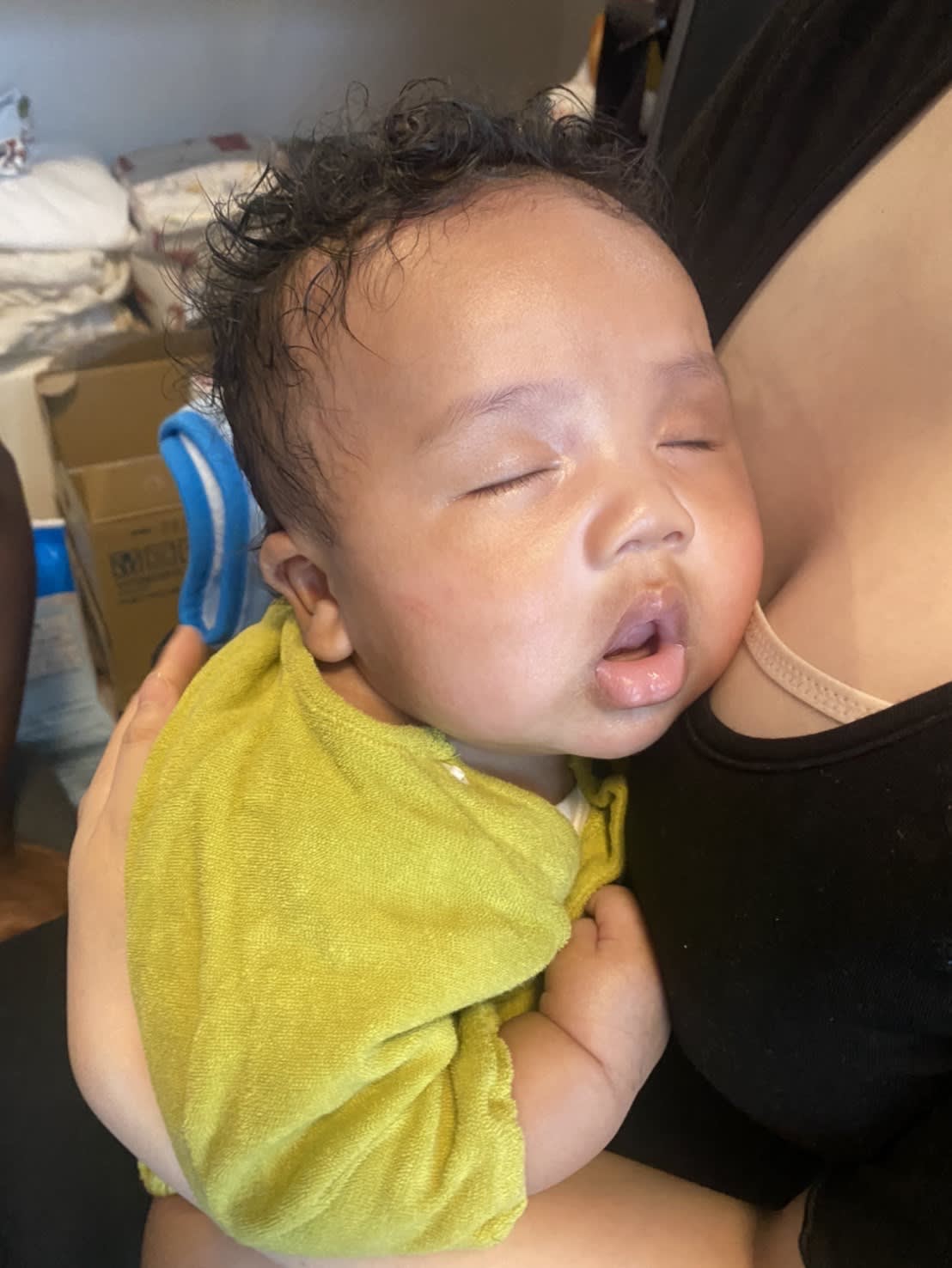 Cute sleeping in mummy's arm