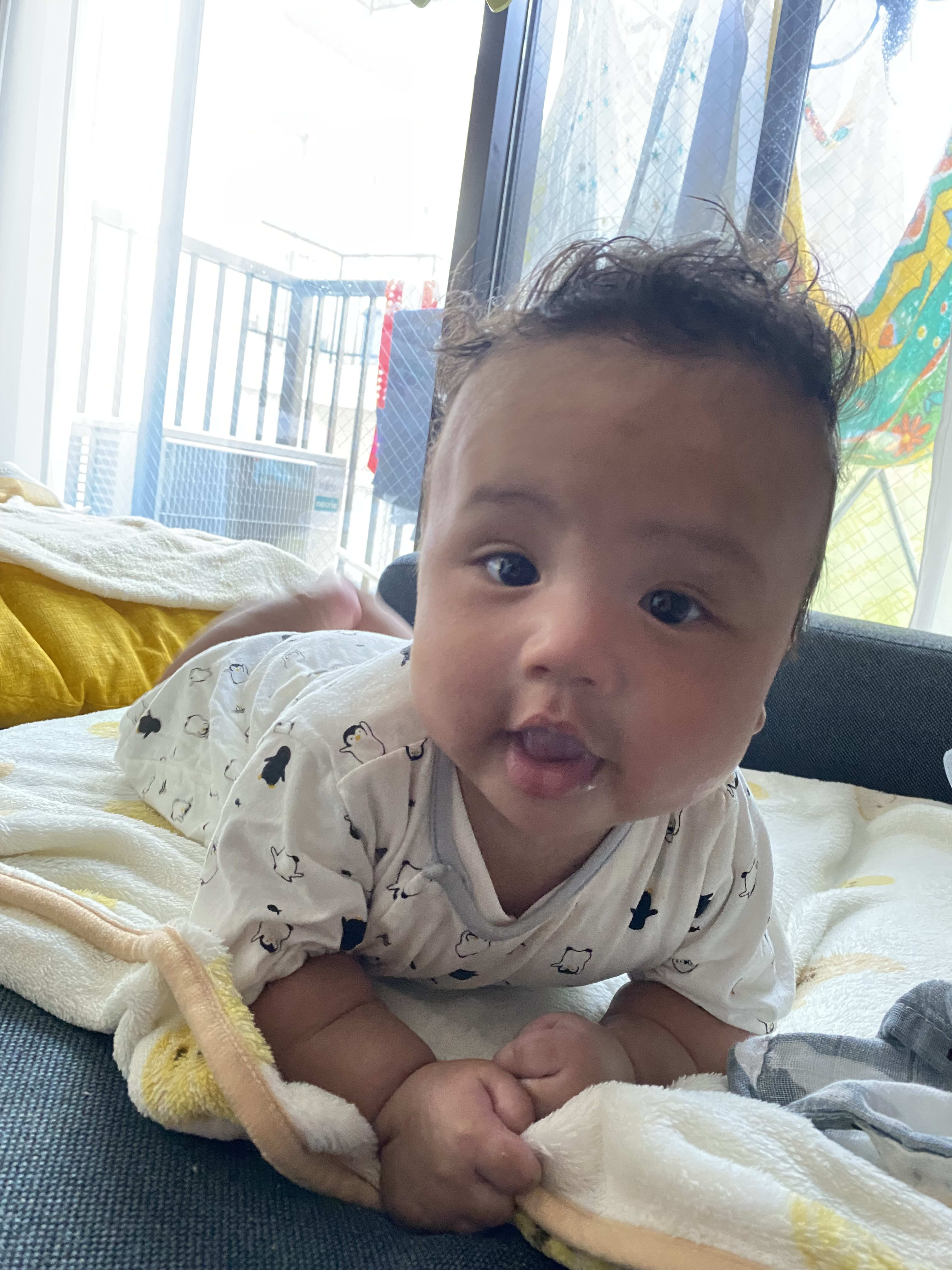 He's getting used to tummy time!