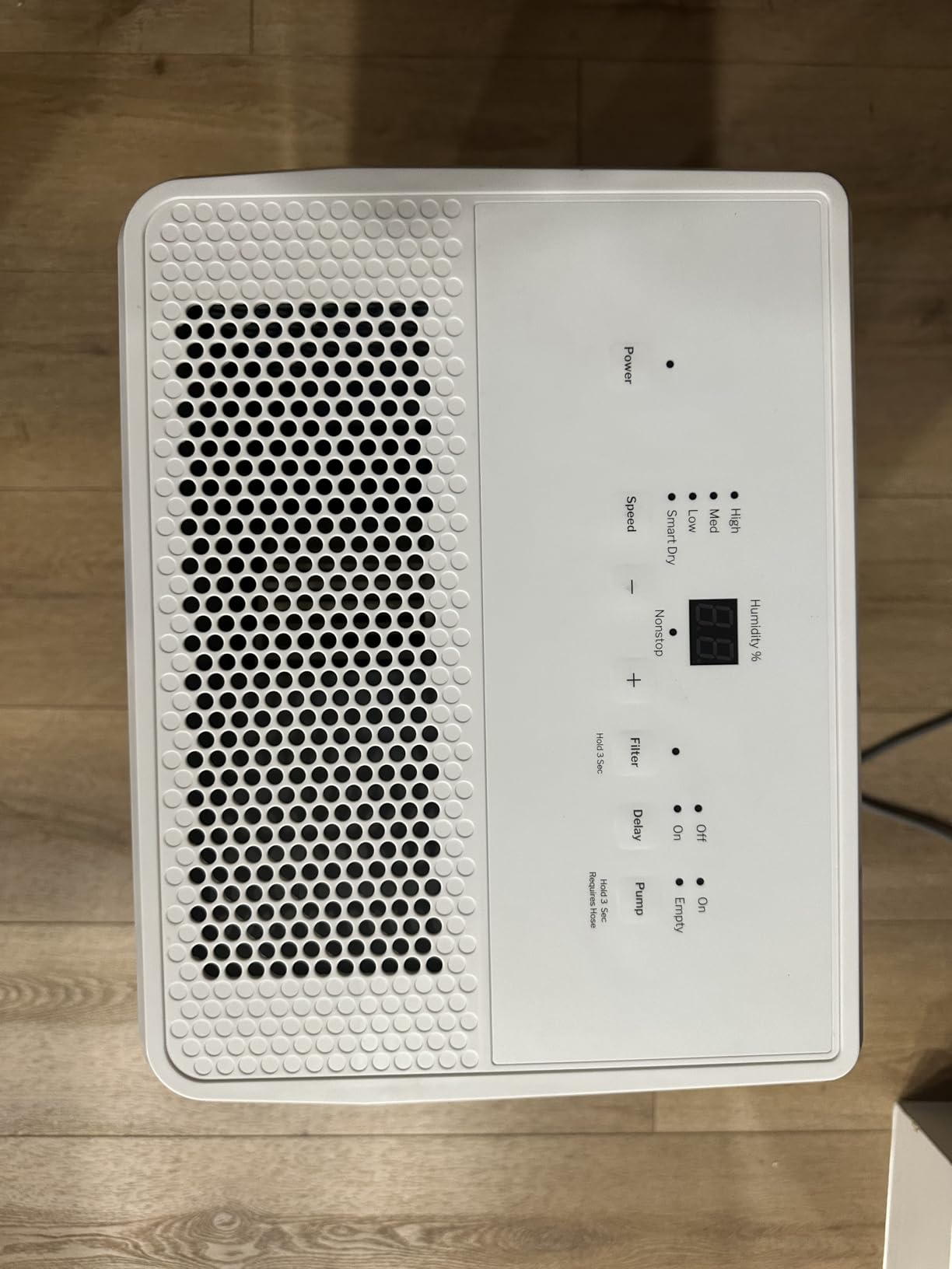Top control panel of the GE dehumidifier showing settings, display, and circular air outlet grille
