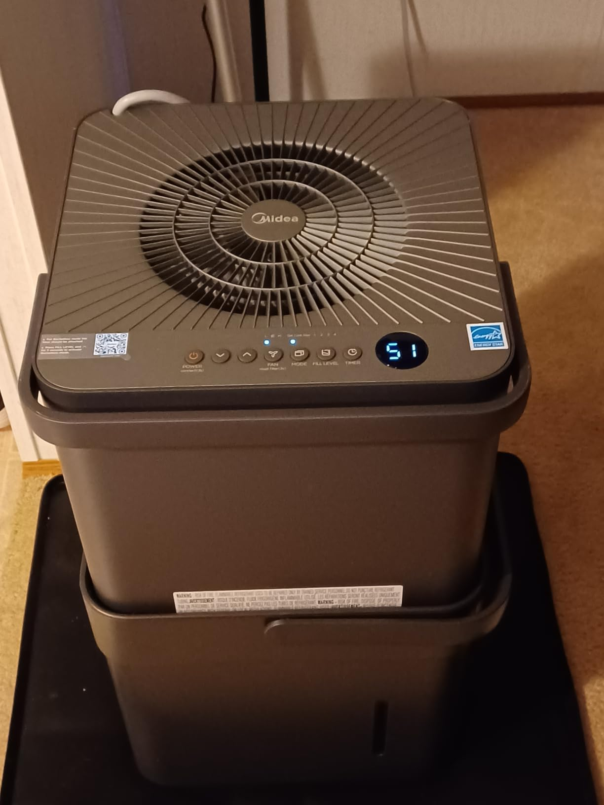 Top-down view of the Midea Cube dehumidifier showing the radial fan grill and digital controls display reading 51
