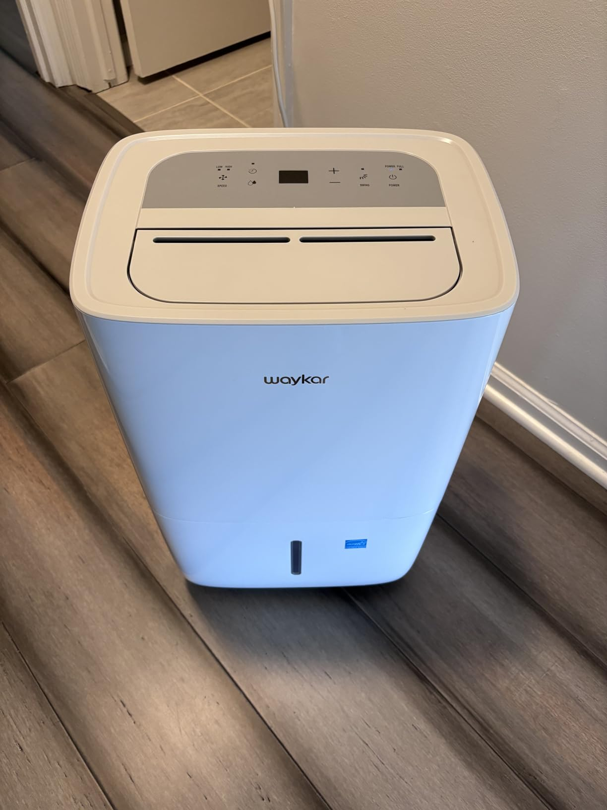 Front-facing view of the white Waykar dehumidifier showing the control panel and water level indicator window