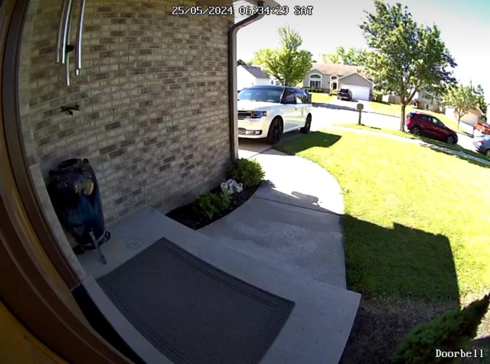 Daytime 5MP camera view from the Reolink Video Doorbell showing the front porch walkway and driveway