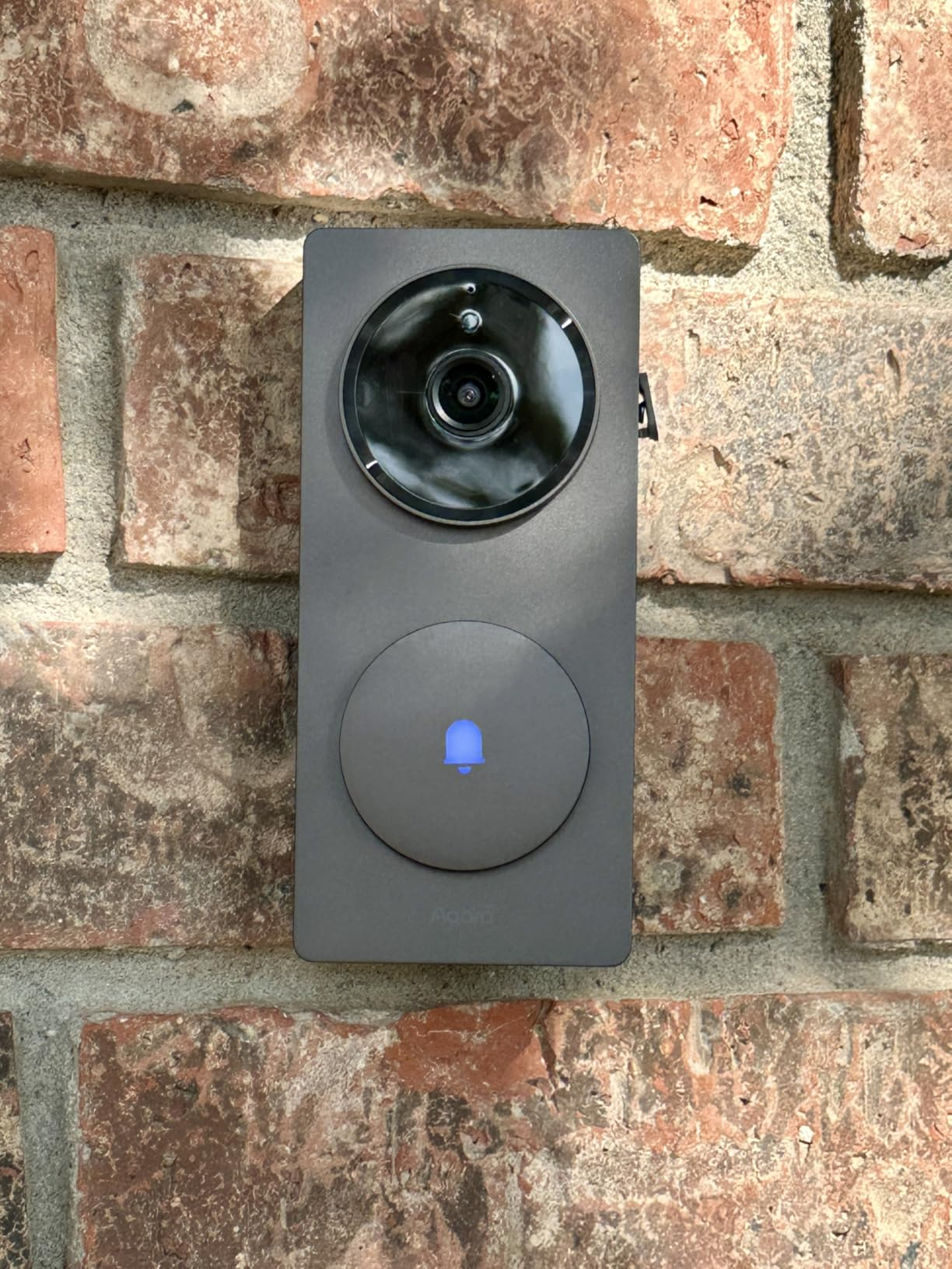 Aqara G410 doorbell unit mounted on a brick wall