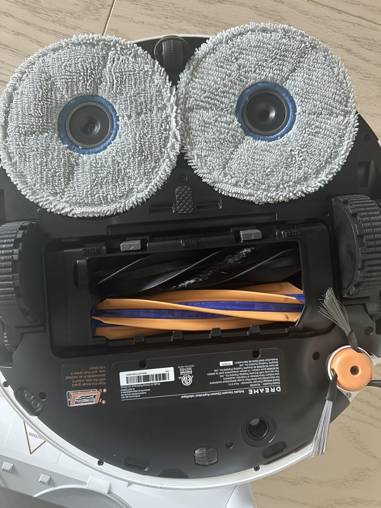 Underside of Dreame X60 Max Ultra showing mop pads and brushes