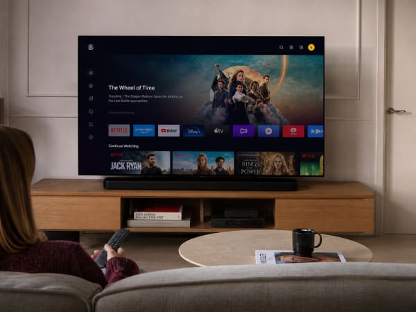 A sleek 4K OLED TV displaying a vibrant HDR scene in a modern living room
