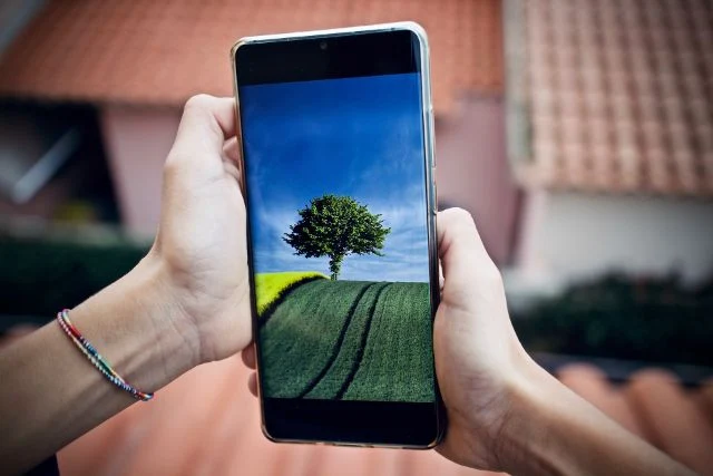 An image showing two hands holding a smartphone.