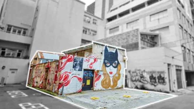 Laneway warehouse adorned with cat woman graphic sold in Melbourne