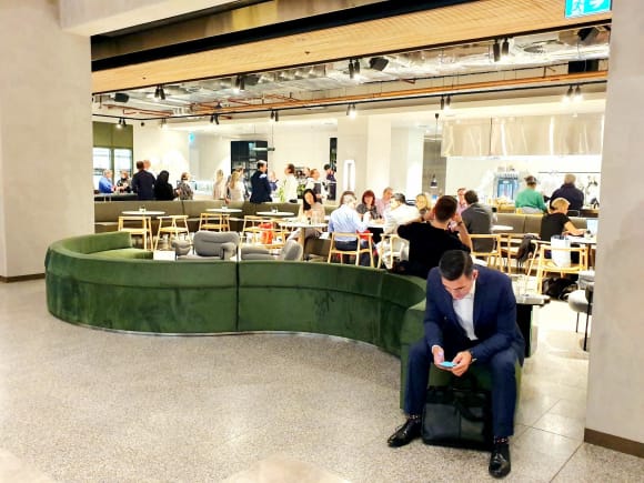 Arced emerald green couch for guests to relax and connect LIMINAL: Melbourne’s trendy new venue could be the CBD’s next best meeting spot