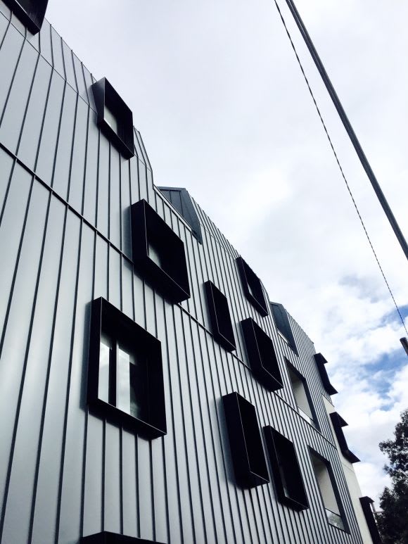 The metallic forms of Assembly with steel reveals to windows. Woods Bagot and Cbus Property's Assembly