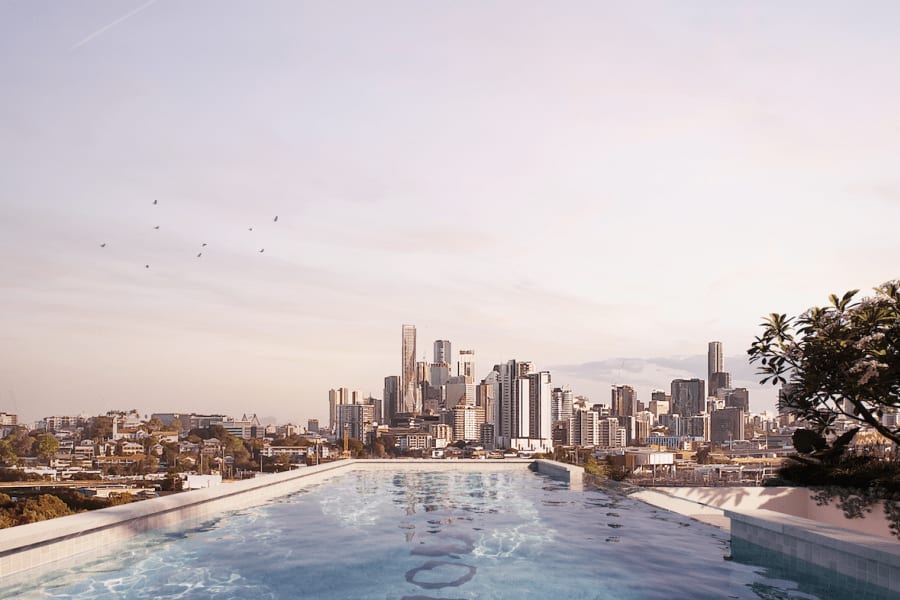 Render of the rooftop deck pool area looking out to the Brisbane city skyline