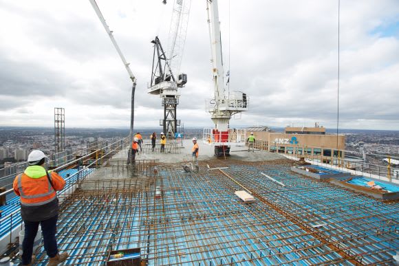 Workers on the rooftop of the South Tower. Image supplied. Multiplex Tops Out QIC’S Collins Street Tower