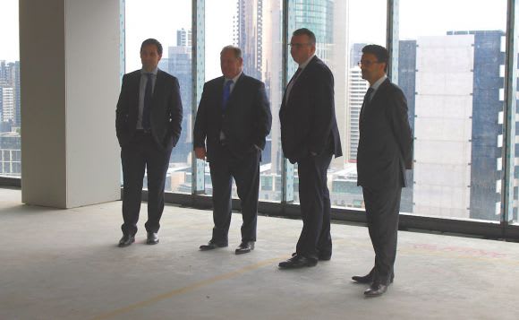 Dignitaries pose for a photo moment 567 Collins Street marks its place in the skyline