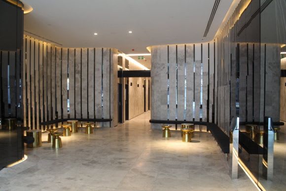 Eq. Tower's cavernous foyer space Three years on, Eq. Tower tops out