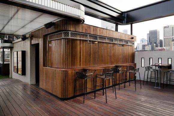 The curved forms draw on the Art Deco Curtin House. Image: Image: Tom Blachford Raising the bar - Technē revamps Rooftop Bar and Cinema