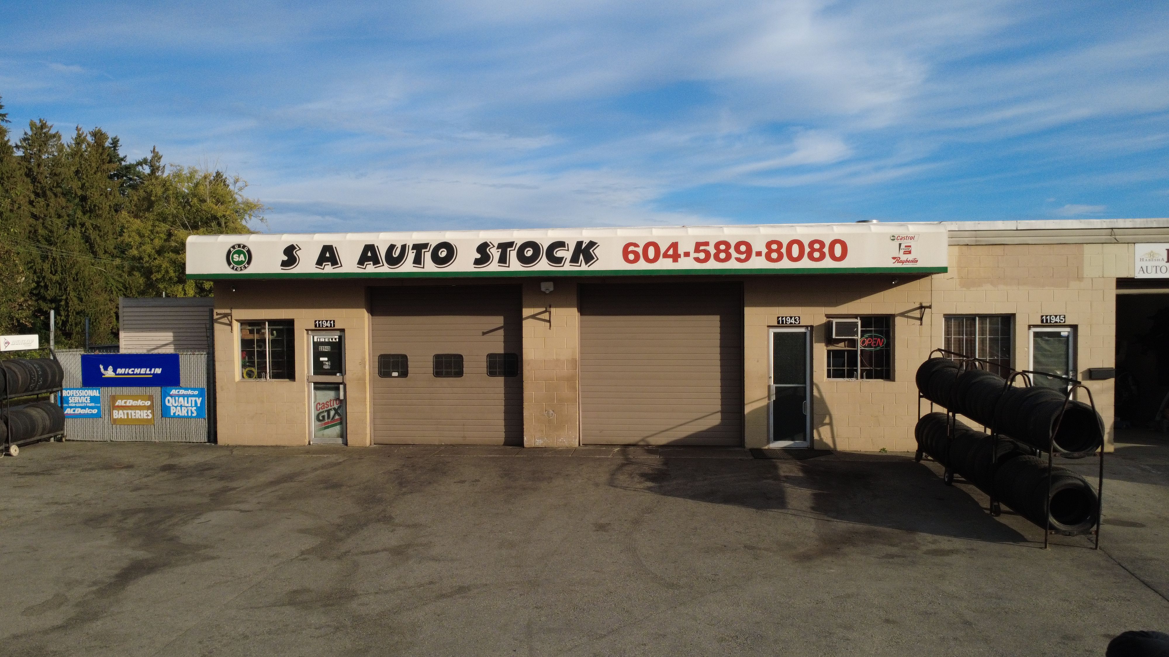 Professional auto mechanics working on a car in a well-lit workshop
