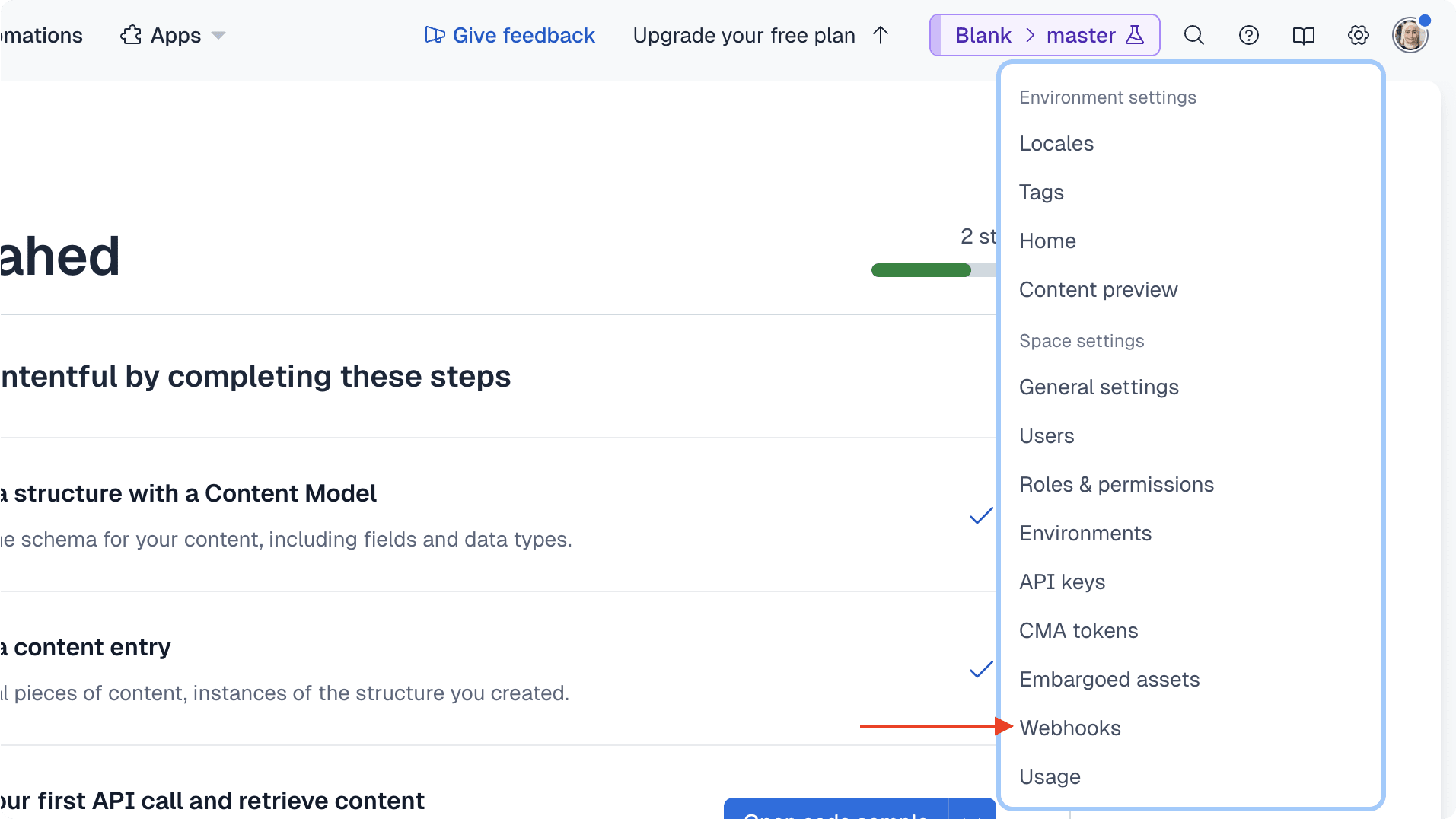 The cog icon is at the top right next to the avatar icon. When you click on it, you see a dropdown with the "Webhooks" option