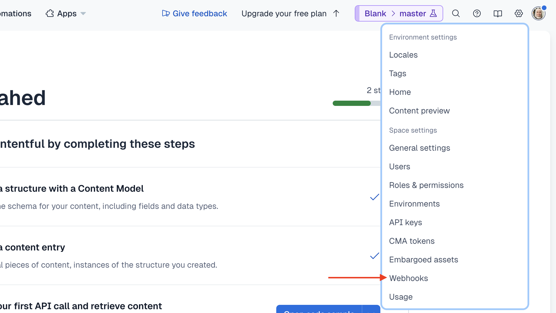 The cog icon is at the top right next to the avatar icon. When you click on it, you see a dropdown with the "Webhooks" option