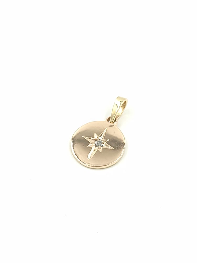 DIJE ESTRELLA DE LUZ EN ORO 18 K Y DIAMANTE