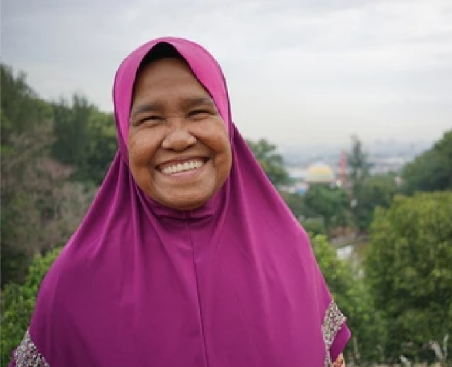 old lady enjoying her smile in a green field 