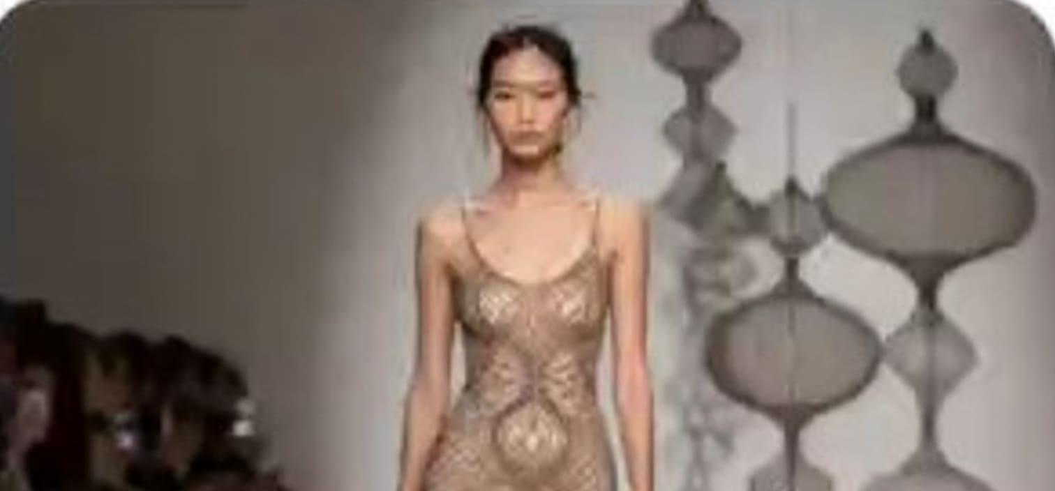 An AI-generated runway rendering of a dress concept inspired by Ruth Asawa's looped-wire sculptures, with large sculptural spheres suspended beside the bodice