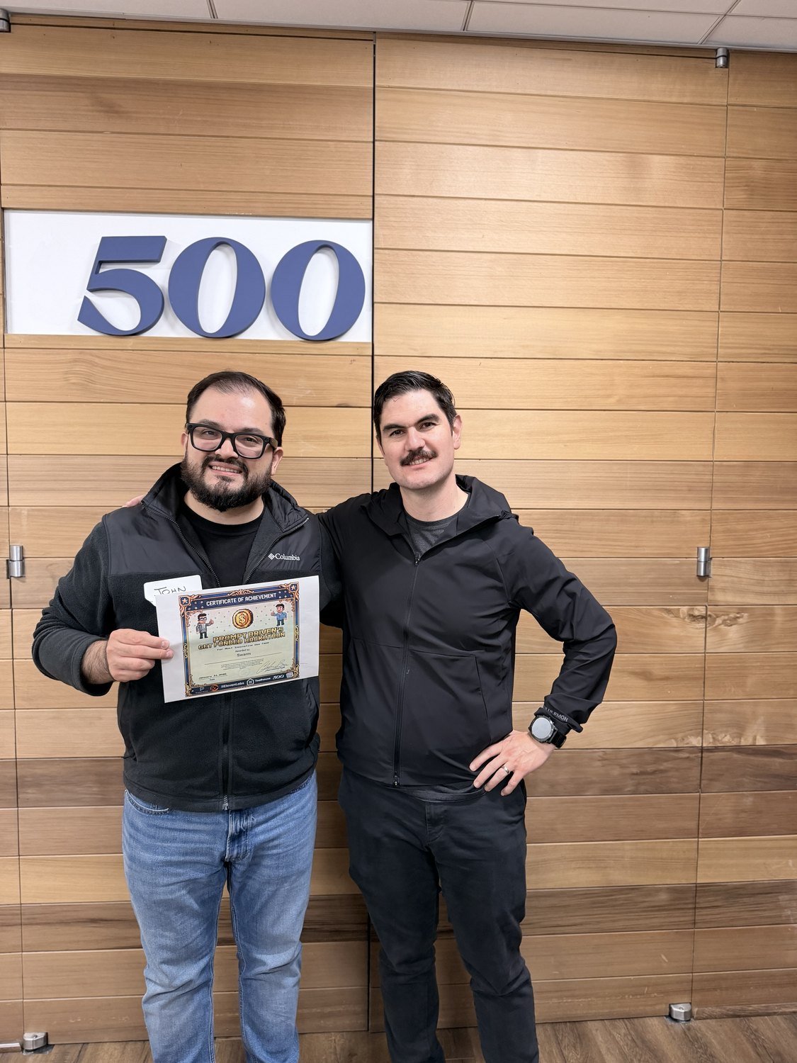 John Olven receiving the award certificate at the 500 Global offices