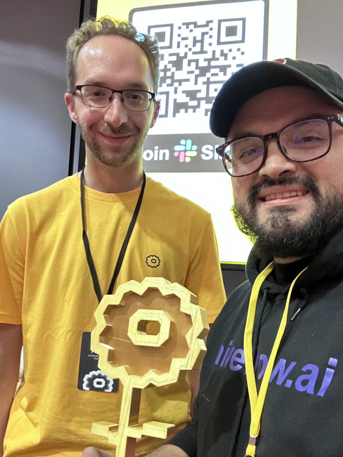 John Olven holding the Decentralized AI Hackathon trophy from Flower Labs at Stanford University