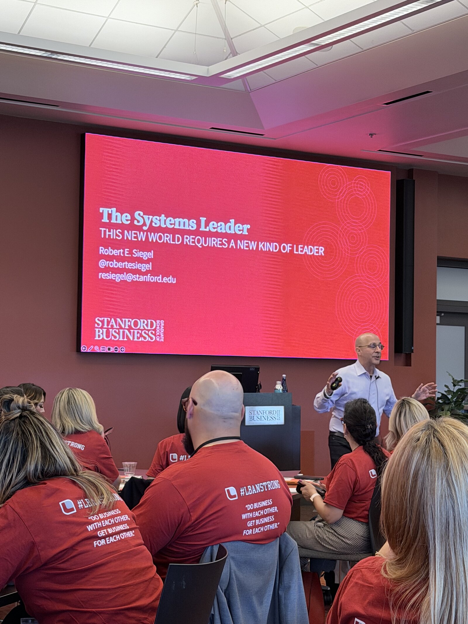 John Olven on the Stanford campus wearing the LBAN program shirt