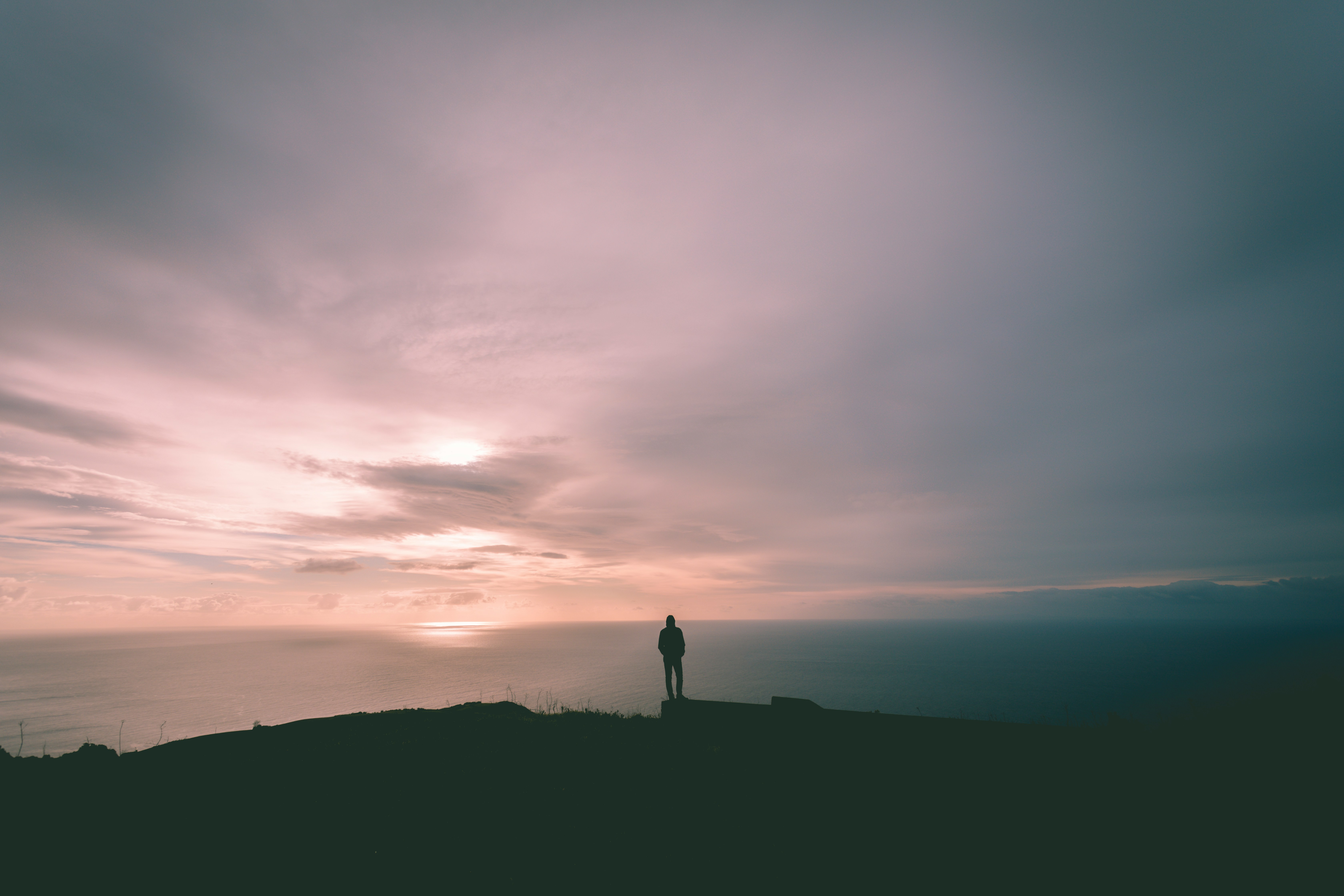 Person standing on mountain summit