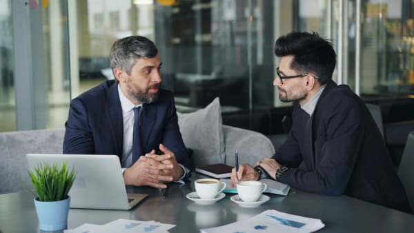 Two professionals in quiet conversation