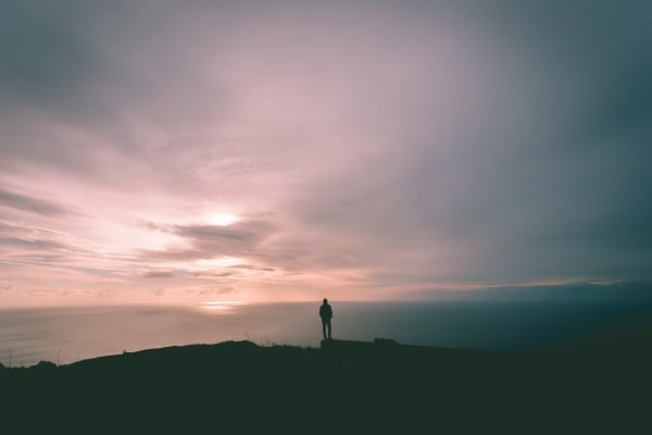Person standing on mountain summit