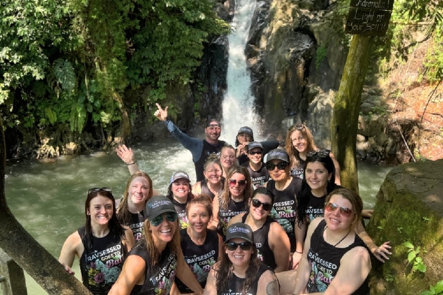 A Travsessed group together at a Bali waterfall