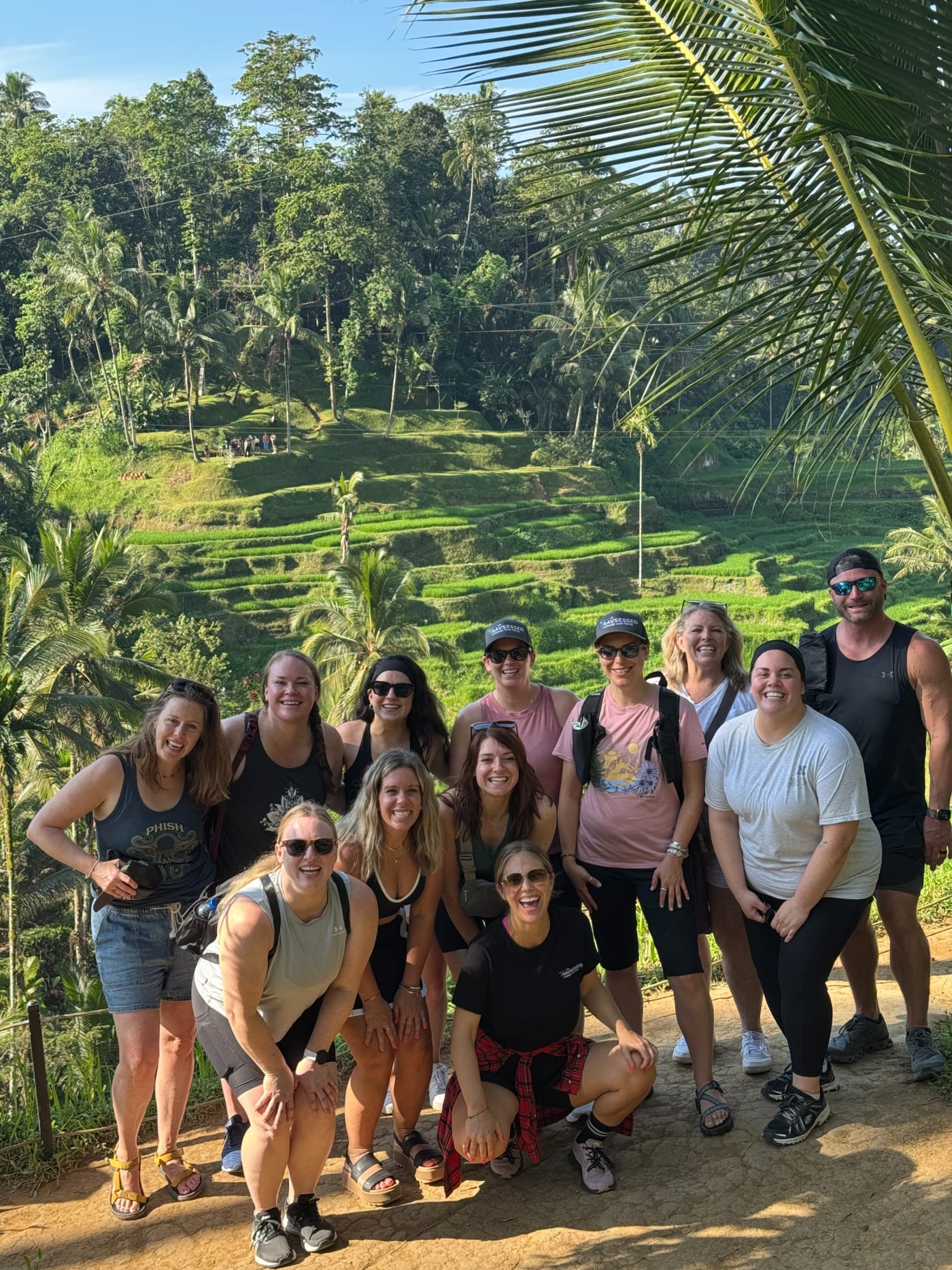 A Travsessed group together above Bali's green rice terraces