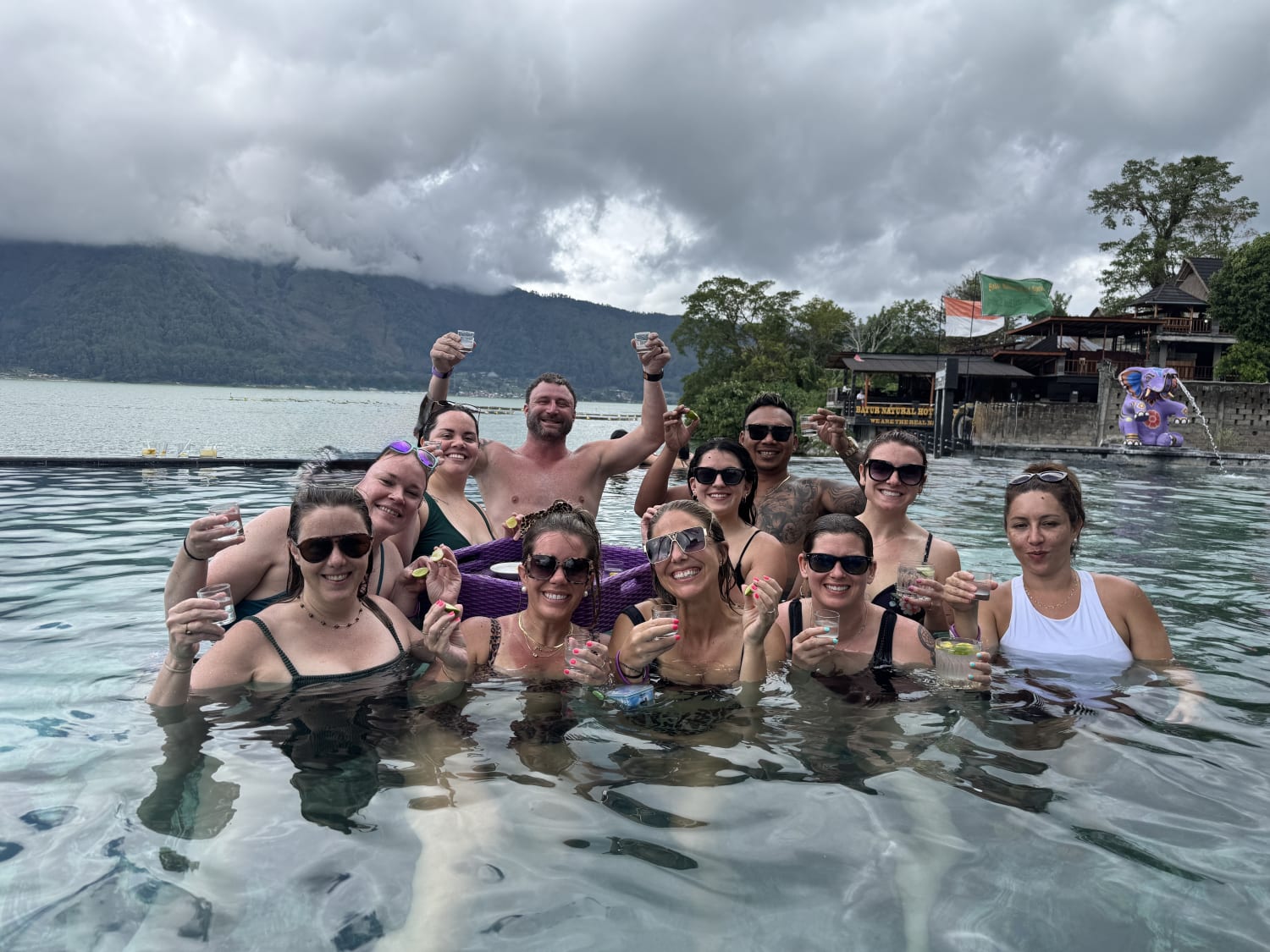 A Travsessed group celebrating together in Bali's mountain hot springs