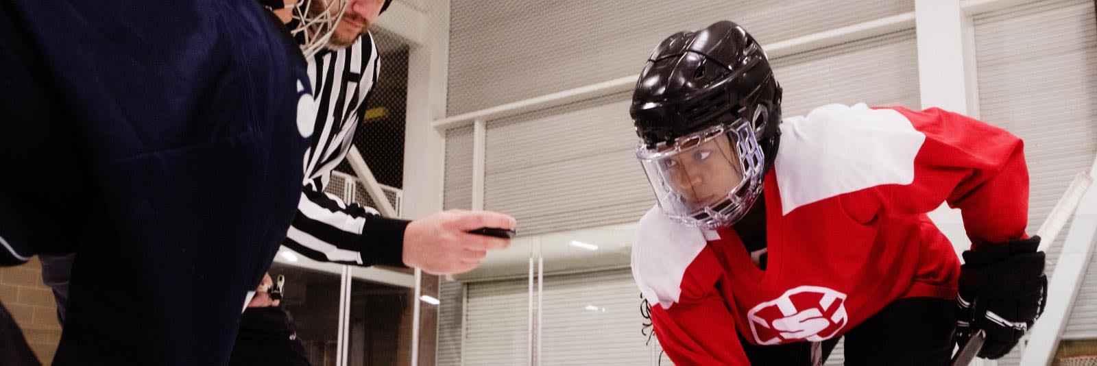 women's hockey players face off