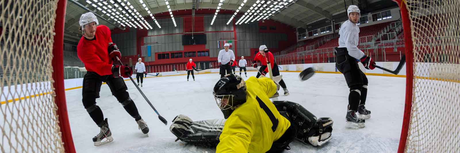 male hockey player scores a goal