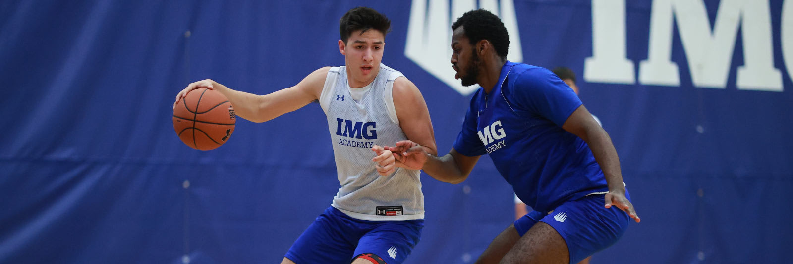 two men's basketball players at a camp