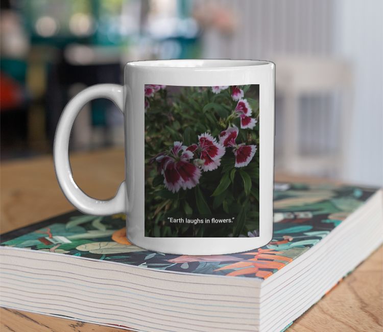 Flowers, earth laughs in flowers.  Coffee Mug