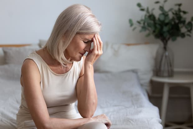 an older woman showing distress. width=