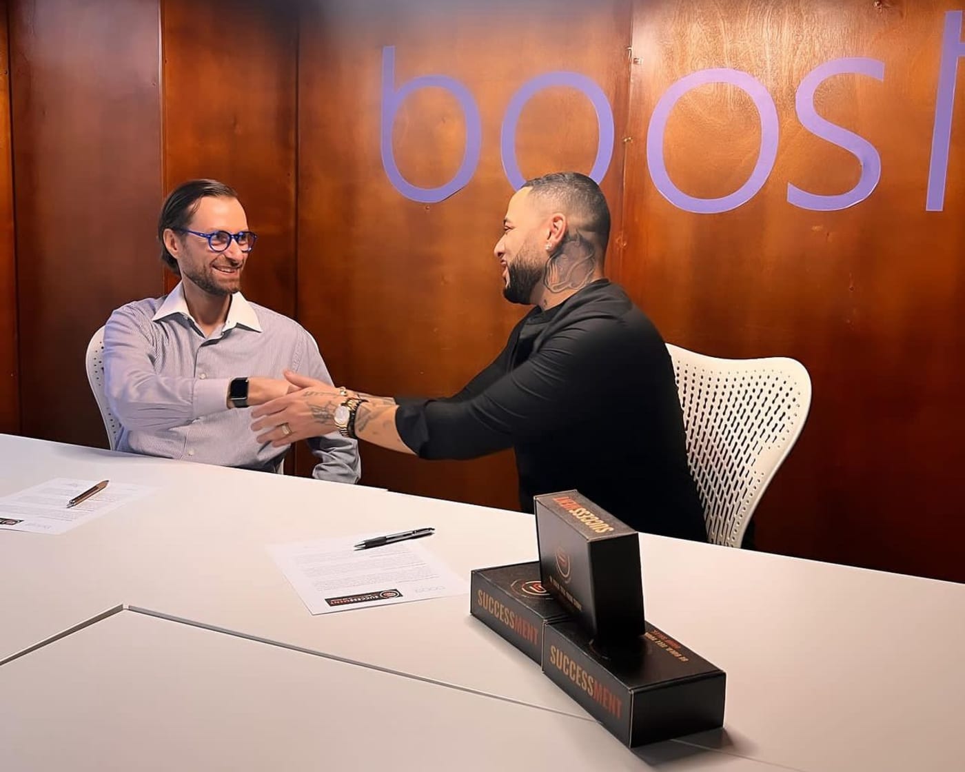 Two professionals in an accelerator advisory conversation at a BOOST workspace
