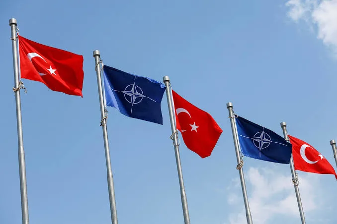"NATO and Turkish flags fly together ahead of the NATO Ankara Summit 2026, symbolizing alliance unity as leaders discuss defence spending, Article 5 commitments, and support for Ukraine."