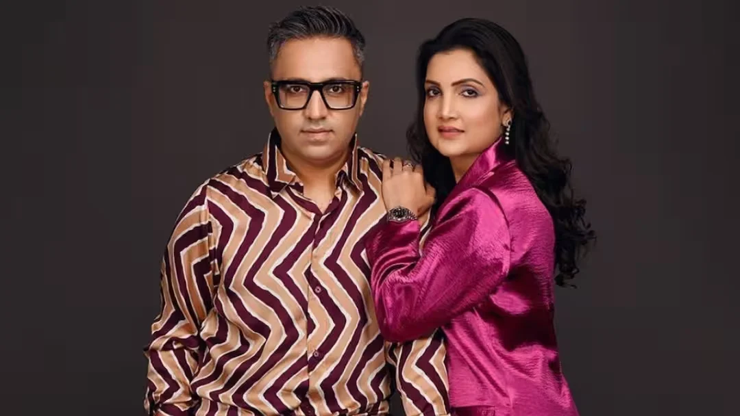 "Madhuri Jain Grover and her husband pose together at a formal event, dressed in elegant traditional attire, amid ongoing attention surrounding the Lock Upp 2 controversy."