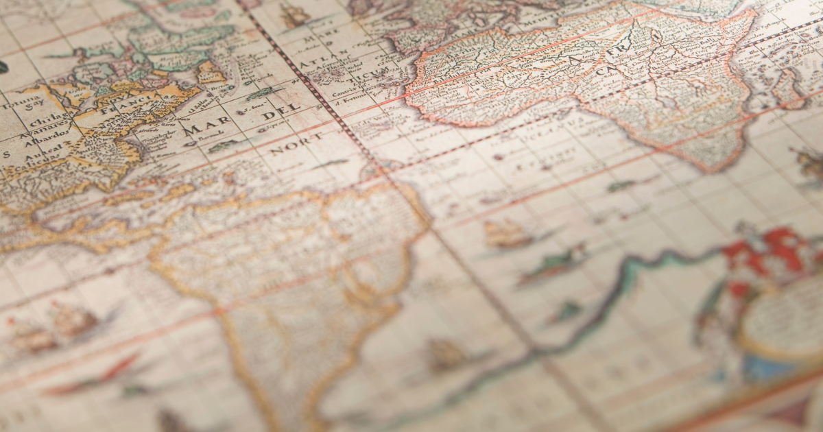 Close-up of a vintage antique world map showing the Atlantic Ocean in old European cartographic style