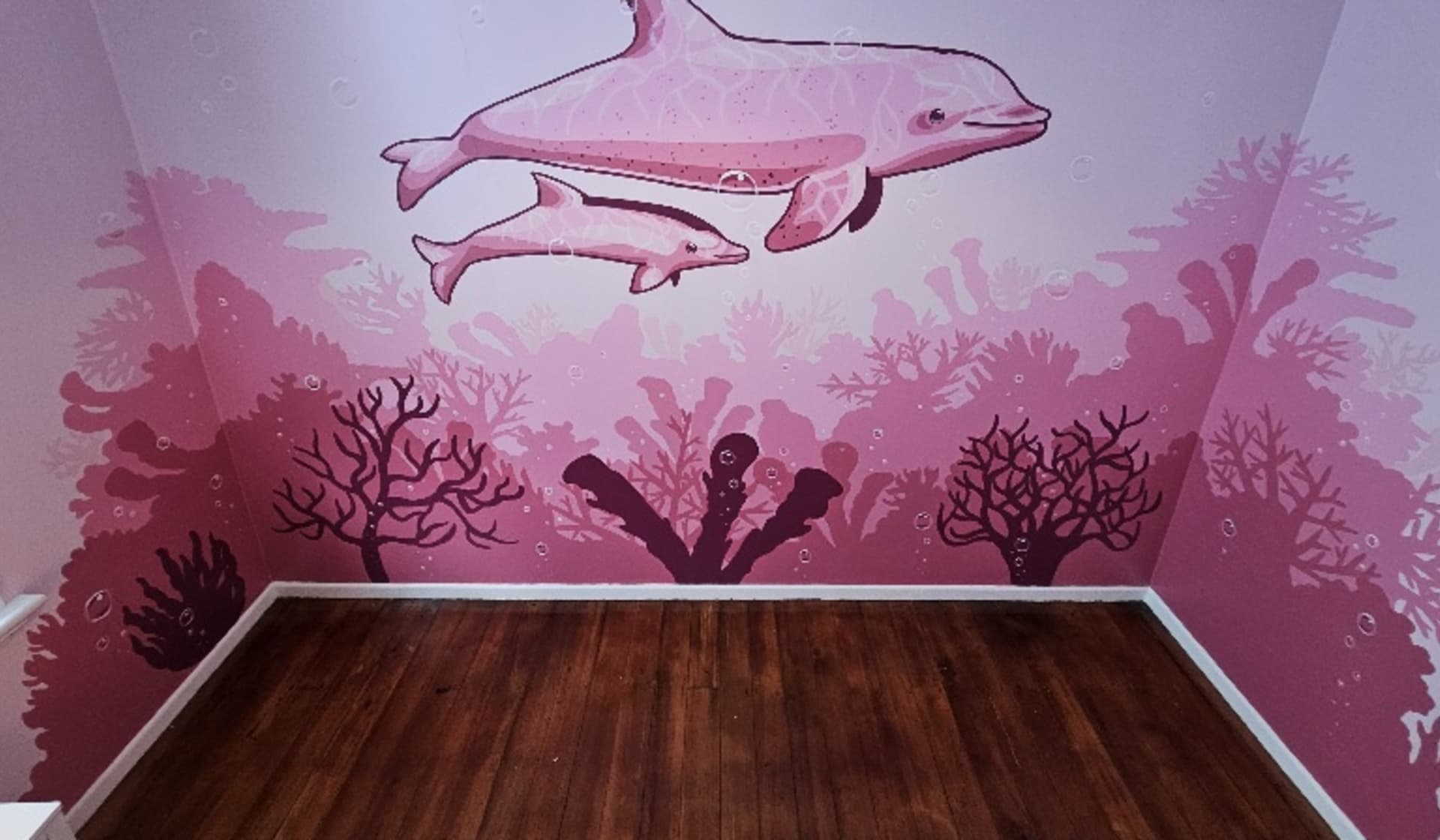 Pink dolphins gliding through coral depths