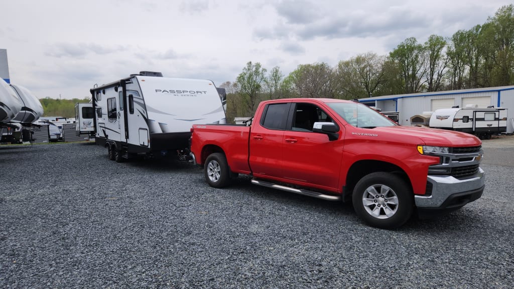 The new camper connected to our red Chevrolet Silverado 1500