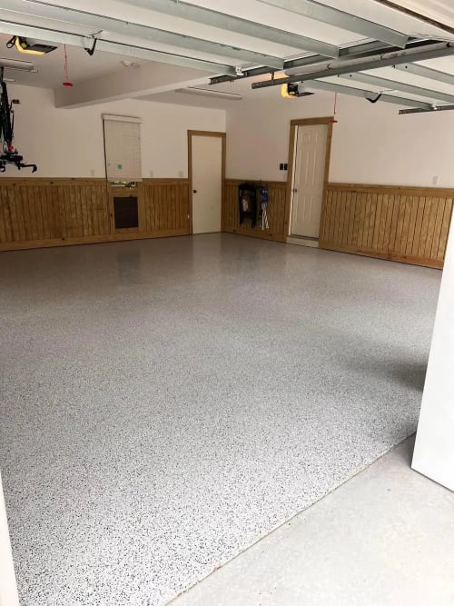 Epoxy garage floor with decorative vinyl chips in a coastal home
