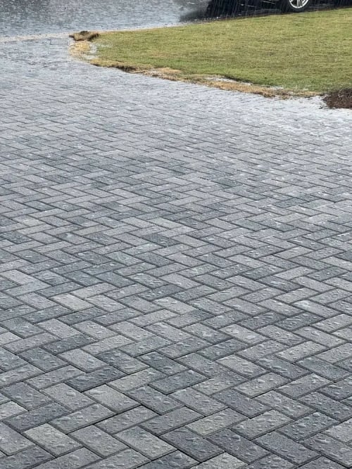 Before and after image of a paver sealing project on a coastal pool deck, showing vibrant color restoration and enhanced joint definition