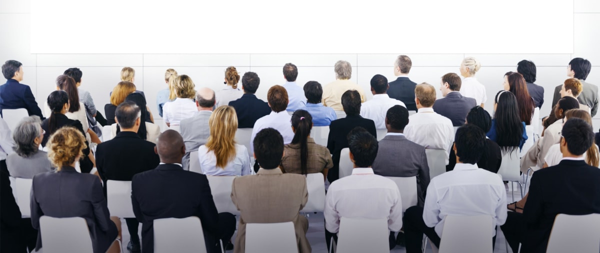 Audience seated at a conference representing advocacy and position statements